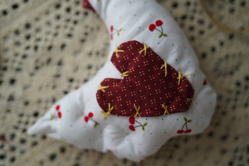 cross stitched heart on the body part of the chicken to create wing shape